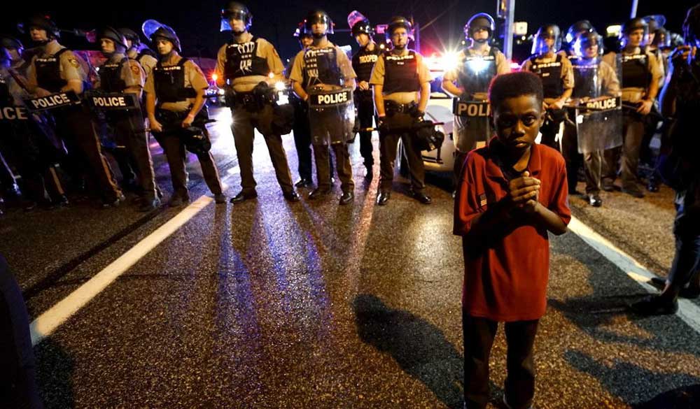 Black-boy-in-front-of-police-line